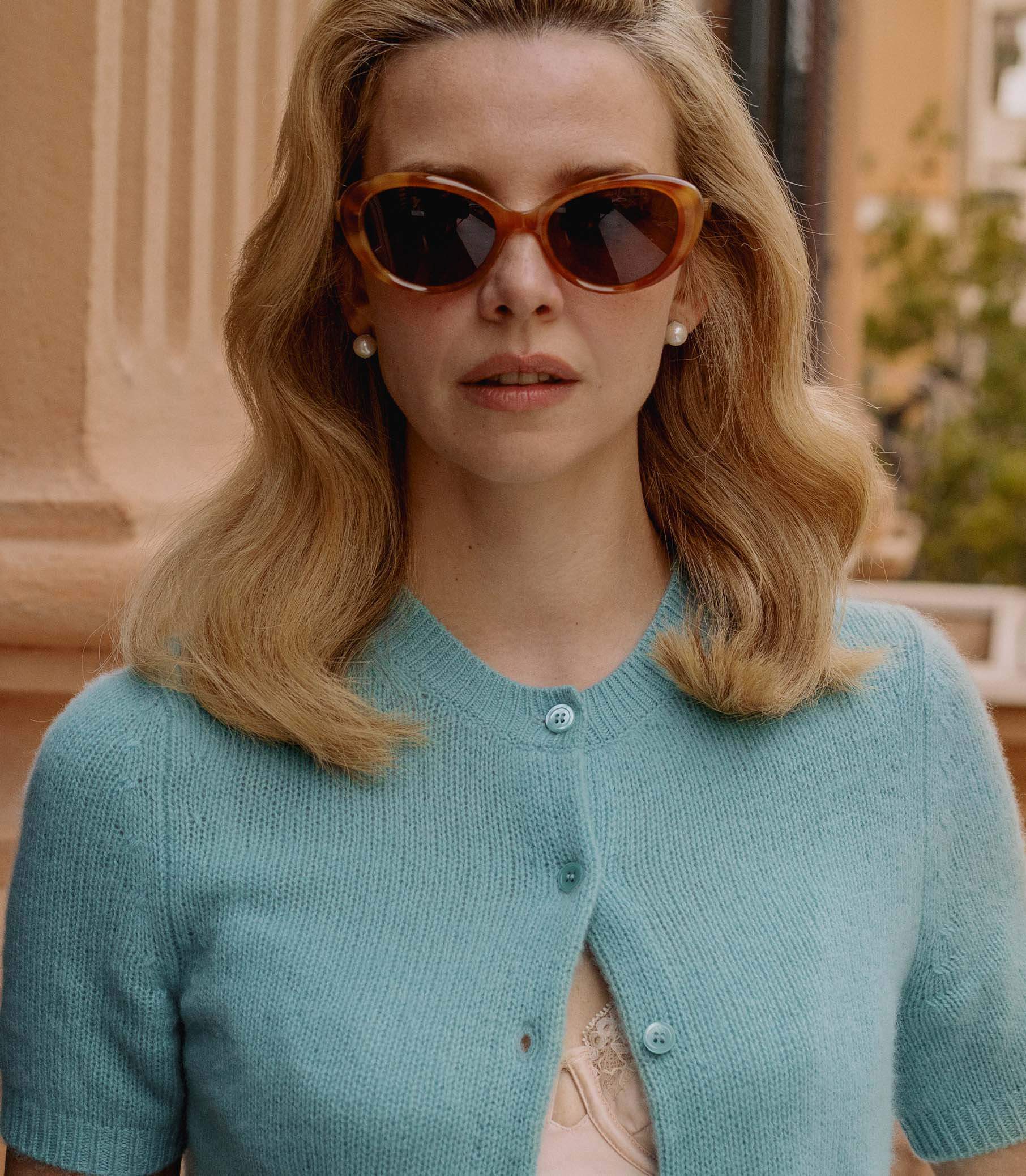 Model showcasing stylish sunglasses and cardigan from the Shoes&Accessories collection.